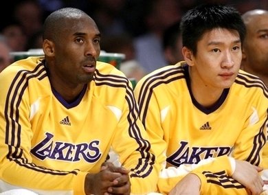 Los Angeles Lakers' Sun Yue and Bryant watch their NBA basketball game against New York Knicks in Los Angeles